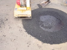 A compacter is shown on the newly placed recycled asphalt.
