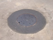 A newly raised manhole ring and cover.